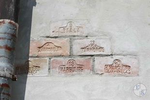 Brick with a stigma of the Jewish manufacturer Margulis, in the wall of the castle Brick with a stigma of the Jewish manufacturer Margulis, in the wall of the castle