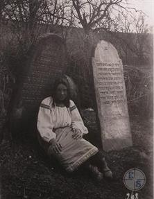 Ukrainian woman at the Jewish cemetery in Kamin-Kashyrskyy, 1918. On the right - the tombstone of Yehuda Levi Hacohen, 1891 Ukrainian woman at the Jewish cemetery in Kamin-Kashyrskyy, 1918. On the right - the tombstone of Yehuda Levi Hacohen, 1891